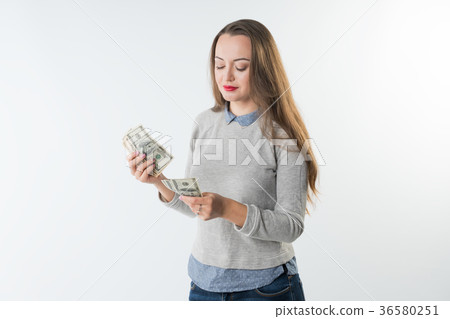 young woman holding dollars cash counting money. 36580251