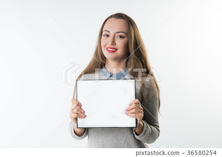 Young woman with an empty plate or frame 36580254