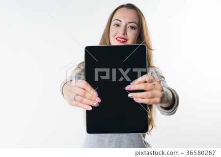 Young woman with an empty tablet screen 36580267