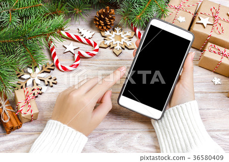 Female buyer makes order at screen of smartphone 36580409