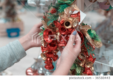 customer girl choosing Christmas tree or New Year 36580443