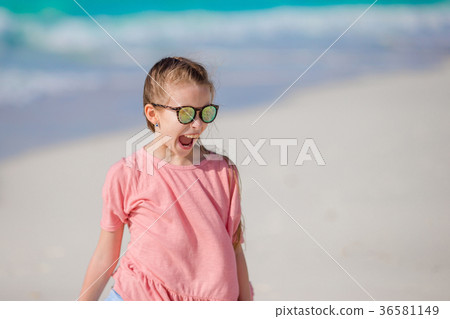 Portrait of adorable little girl at beach during Portrait of adorable little girl at beach during 36581149
