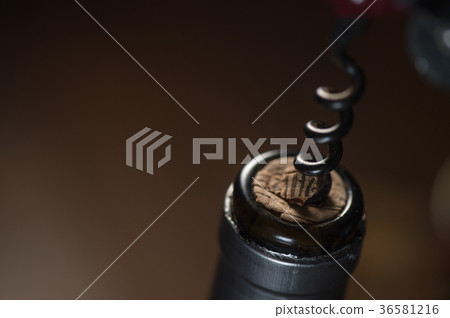 Opening a wine bottle with corkscrew,  36581216
