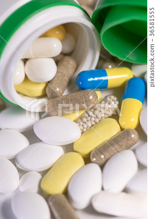 Colored pills, tablets and capsules on white Colored pills, tablets and capsules on white 36581555