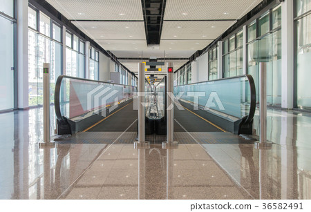 long walkway of escalator at international airport 36582491