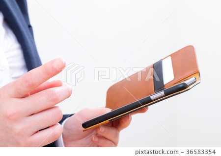 Women's hands touching mobile in office Copy space Smart phone Smartphone Mobile phone White background Women's hands touching mobile in office Copy space Smart phone Smartphone Mobile phone White background 36583354