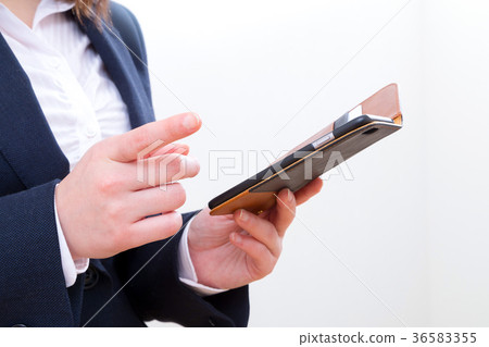 Women's hands touching mobile in office Copy space Smart phone Smartphone Mobile phone White background Women's hands touching mobile in office Copy space Smart phone Smartphone Mobile phone White background 36583355