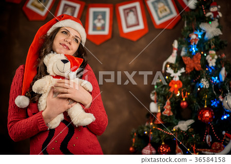 Indoor Christmas portrait of the dreamy smiling Indoor Christmas portrait of the dreamy smiling 36584158