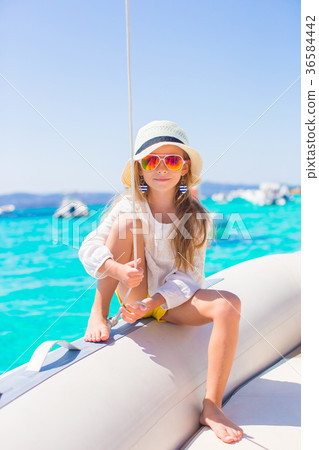 Little girl enjoying sailing on boat in the open Little girl enjoying sailing on boat in the open 36584442