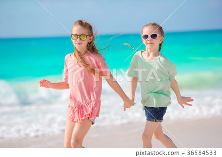 Adorable little girls have fun together on white Adorable little girls have fun together on white 36584533