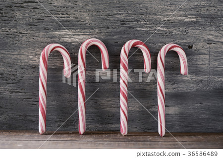 candy canes on a rustic wooden background 36586489