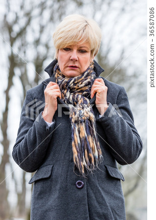 Depressed or sad woman walking in winter 36587086