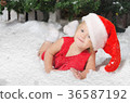 smiling girl in santa costume on snow 36587192
