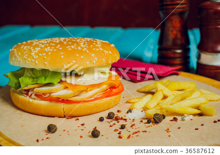 burger with meat cutlet, on turquoise table. burger with meat cutlet, on turquoise table. 36587612