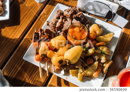 Baked potatoes with vegetables, meat and shish Baked potatoes with vegetables, meat and shish 36590699