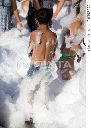 Youth at a foamy party on the beach 36592372