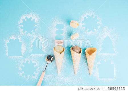 Macaroons in a waffle cone with powdered sugar. Macaroons in a waffle cone with powdered sugar. 36592815