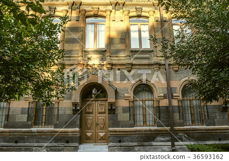 Building of multicolored tufa stone with arches 36593162