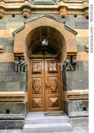 Arched visor with a console over the wooden door 36593164