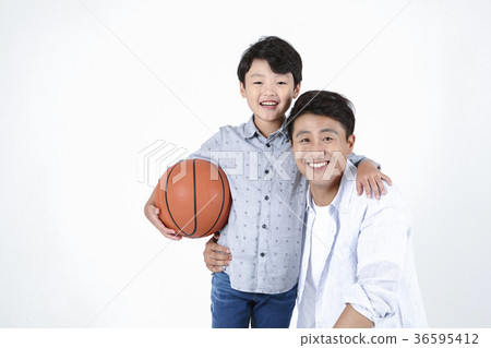 Young father and son playing with a ball and riding a bicycle together portrait. Studio shot. 058 Young father and son playing with a ball and riding a bicycle together portrait. Studio shot. 058 36595412