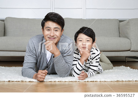 Young father and son take a rest in the living room 144 Young father and son take a rest in the living room 144 36595527