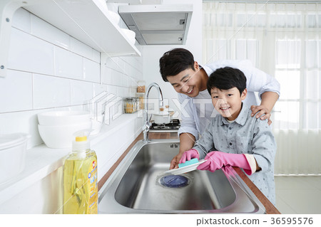 Young father with son preparing dishes, and dish washing together. 328 Young father with son preparing dishes, and dish washing together. 328 36595576