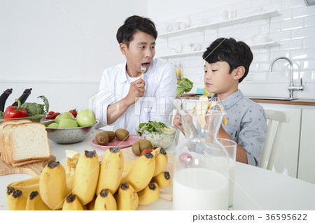 Young father with son preparing dishes, and dish washing together. 346 Young father with son preparing dishes, and dish washing together. 346 36595622