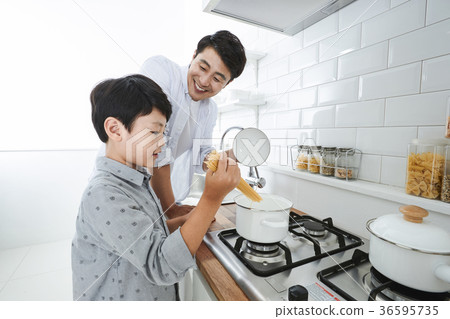 Young father with son preparing dishes, and dish washing together. 335 Young father with son preparing dishes, and dish washing together. 335 36595735