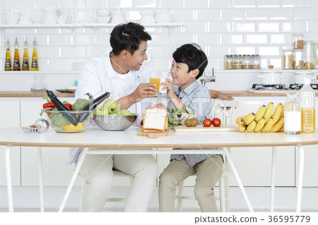 Young father with son preparing dishes, and dish washing together. 356 Young father with son preparing dishes, and dish washing together. 356 36595779