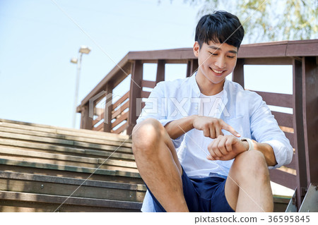 Young guy take a relax in park, sit on green grass and walking in around. 017 Young guy take a relax in park, sit on green grass and walking in around. 017 36595845
