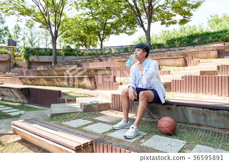 Young guy take a relax in park, sit on green grass and walking in around. 043 Young guy take a relax in park, sit on green grass and walking in around. 043 36595891