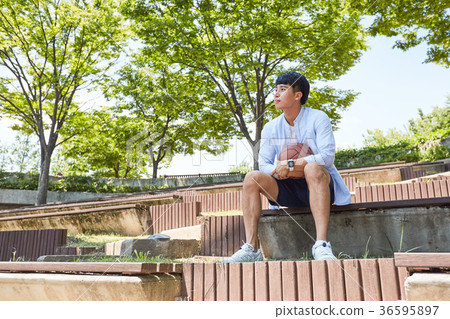 Young guy take a relax in park, sit on green grass and walking in around. 033 Young guy take a relax in park, sit on green grass and walking in around. 033 36595897