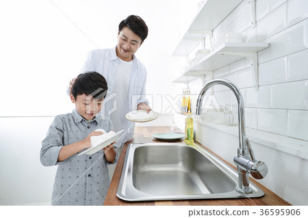 Young father with son preparing dishes, and dish washing together. 329 Young father with son preparing dishes, and dish washing together. 329 36595906