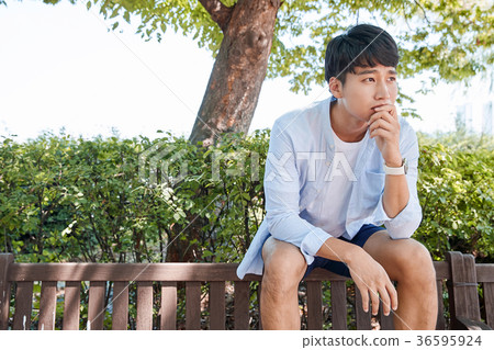 Young guy take a relax in park, sit on green grass and walking in around. 051 Young guy take a relax in park, sit on green grass and walking in around. 051 36595924