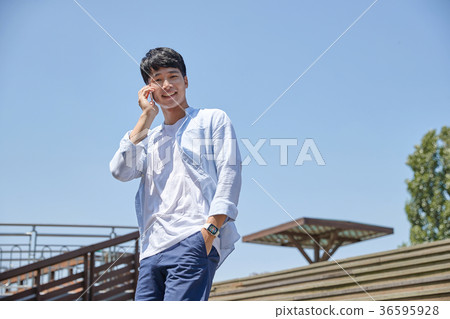 Young guy take a relax in park, sit on green grass and walking in around. 013 Young guy take a relax in park, sit on green grass and walking in around. 013 36595928