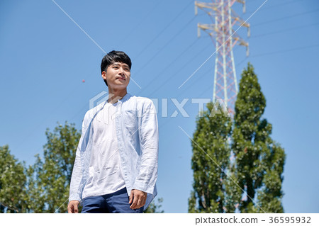 Young guy take a relax in park, sit on green grass and walking in around. 002 Young guy take a relax in park, sit on green grass and walking in around. 002 36595932