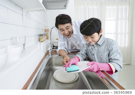Young father with son preparing dishes, and dish washing together. 330 Young father with son preparing dishes, and dish washing together. 330 36595969