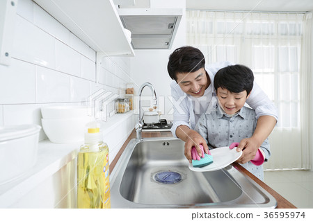 Young father with son preparing dishes, and dish washing together. 332 Young father with son preparing dishes, and dish washing together. 332 36595974
