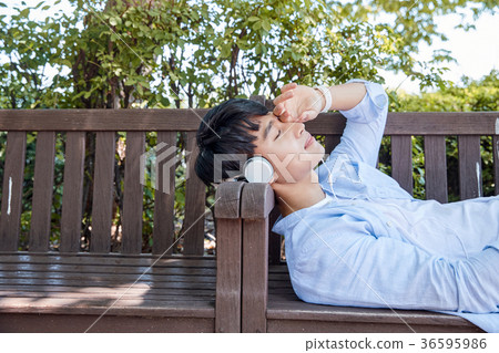 Young guy take a relax in park, sit on green grass and walking in around. 058 Young guy take a relax in park, sit on green grass and walking in around. 058 36595986