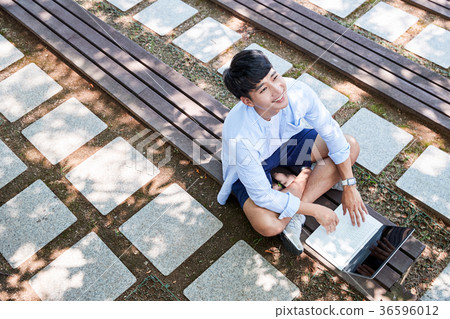 Young guy take a relax in park, sit on green grass and walking in around. 065 Young guy take a relax in park, sit on green grass and walking in around. 065 36596012
