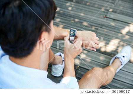 Young guy take a relax in park, sit on green grass and walking in around. 014 Young guy take a relax in park, sit on green grass and walking in around. 014 36596017