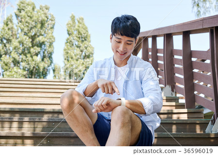 Young guy take a relax in park, sit on green grass and walking in around. 015 Young guy take a relax in park, sit on green grass and walking in around. 015 36596019