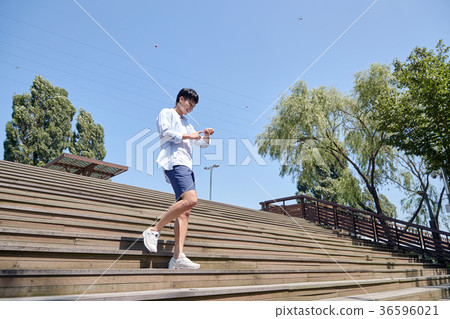 Young guy take a relax in park, sit on green grass and walking in around. 012 Young guy take a relax in park, sit on green grass and walking in around. 012 36596021