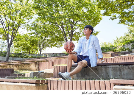 Young guy take a relax in park, sit on green grass and walking in around. 038 Young guy take a relax in park, sit on green grass and walking in around. 038 36596023