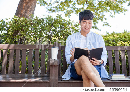 Young guy take a relax in park, sit on green grass and walking in around. 080 Young guy take a relax in park, sit on green grass and walking in around. 080 36596054