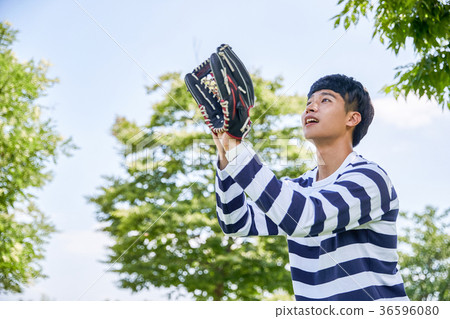 Young guy take a relax in park, sit on green grass and walking in around. 093 36596080