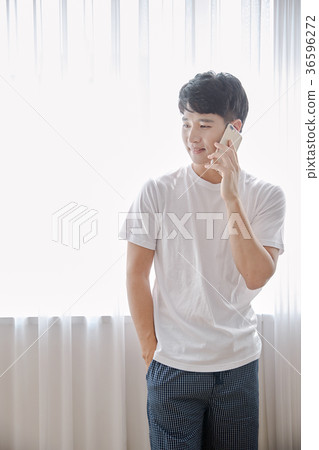 Young guy standing at the front of window with bright sunlight. 172 36596272