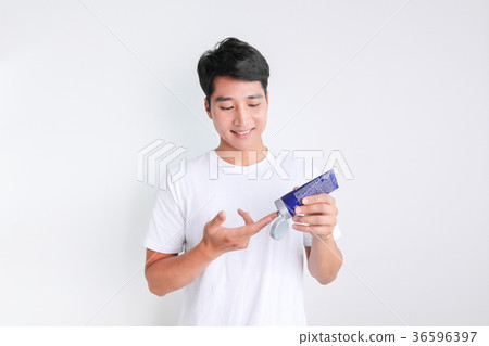 A mugshot of Young guy.- shaving, put lotion, hair dryer, etc. 252 36596397