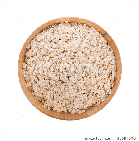 Oat flakes pile in bowl on white background 36597540
