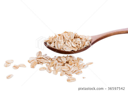 Oat flakes pile in wooden spoon on white 36597542